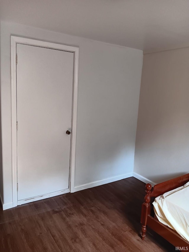 unfurnished bedroom with dark hardwood / wood-style floors