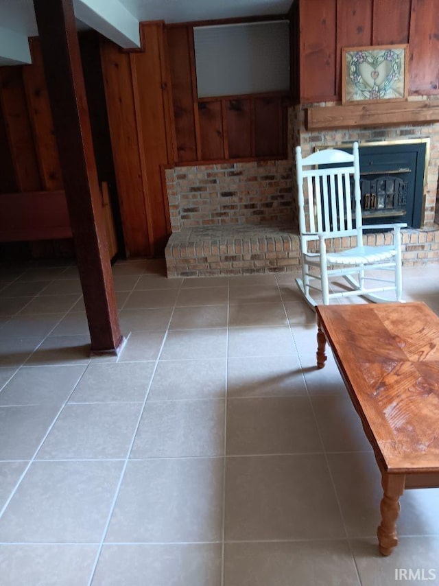 interior space featuring light tile patterned floors and wood walls