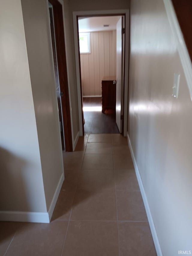 hall featuring dark tile patterned floors