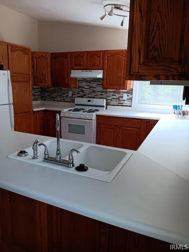 kitchen with white appliances, tasteful backsplash, and vaulted ceiling