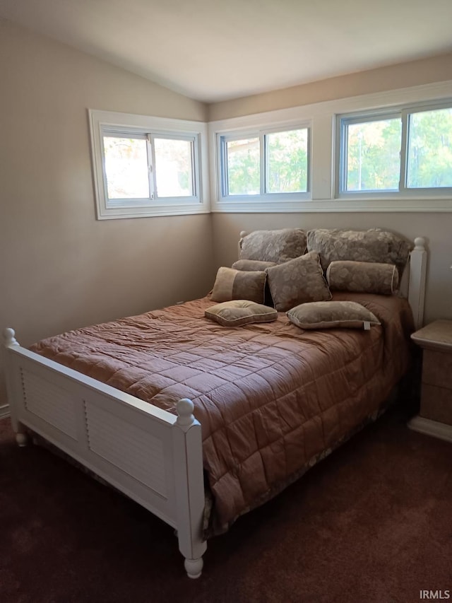 bedroom featuring dark carpet