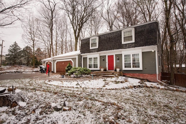 cape cod-style house featuring a garage