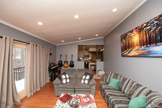 living room with vaulted ceiling, light wood-type flooring, a textured ceiling, and ornamental molding