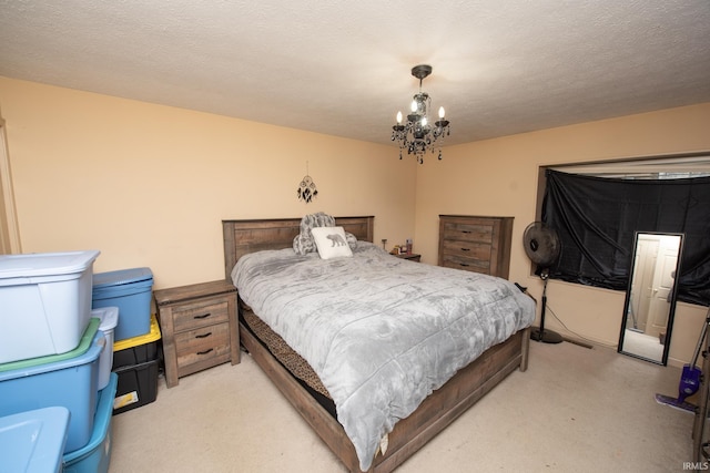 bedroom with a textured ceiling and an inviting chandelier