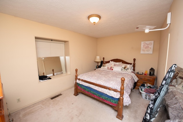 bedroom featuring carpet flooring and a textured ceiling