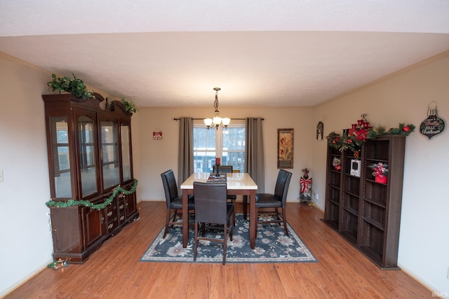 dining room featuring a chandelier and light hardwood / wood-style flooring