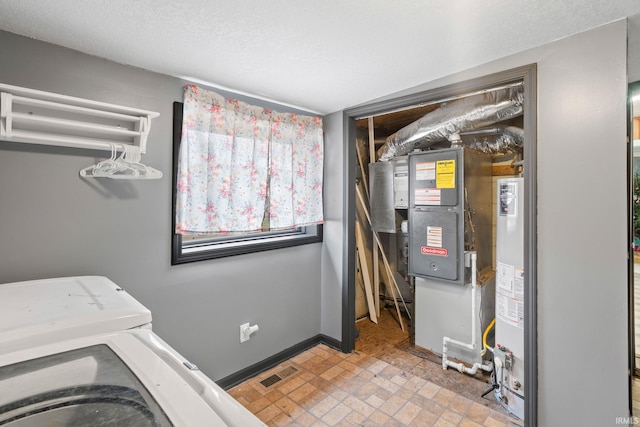 laundry area featuring washing machine and dryer and gas water heater