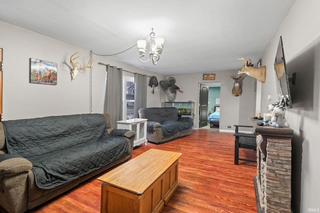 living room with a chandelier and wood-type flooring