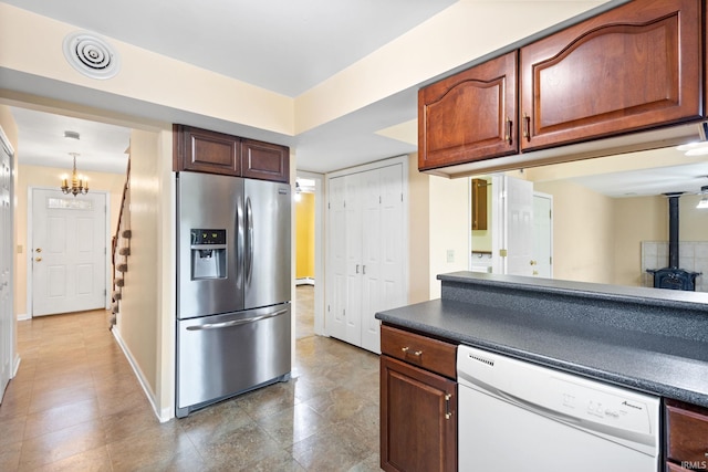 kitchen featuring white dishwasher, stainless steel refrigerator with ice dispenser, and a notable chandelier