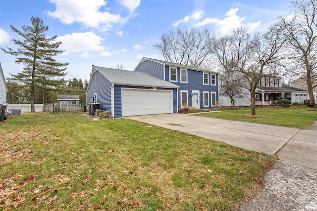 view of front of property featuring cooling unit, a front yard, and a garage