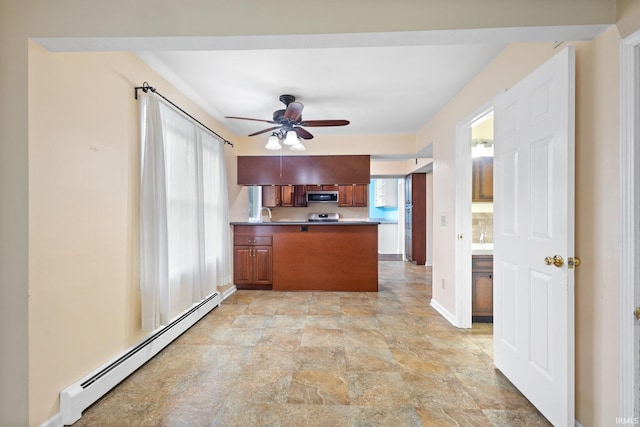 kitchen featuring kitchen peninsula, a wealth of natural light, a baseboard radiator, and range