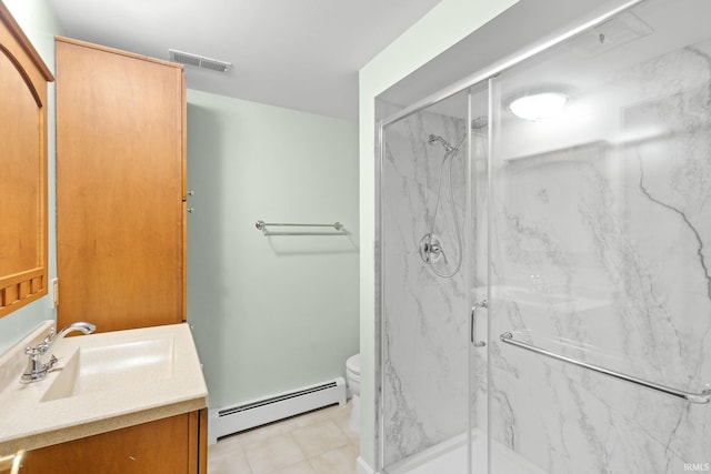 bathroom featuring vanity, tile patterned floors, toilet, baseboard heating, and an enclosed shower