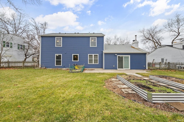 back of house featuring a yard and a patio