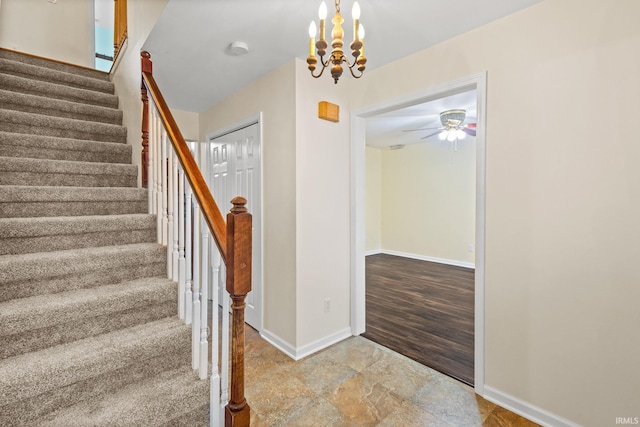 entrance foyer featuring wood-type flooring and ceiling fan with notable chandelier