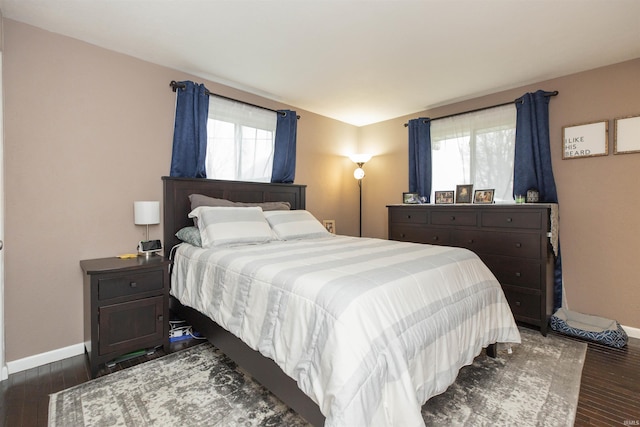 bedroom with dark hardwood / wood-style flooring