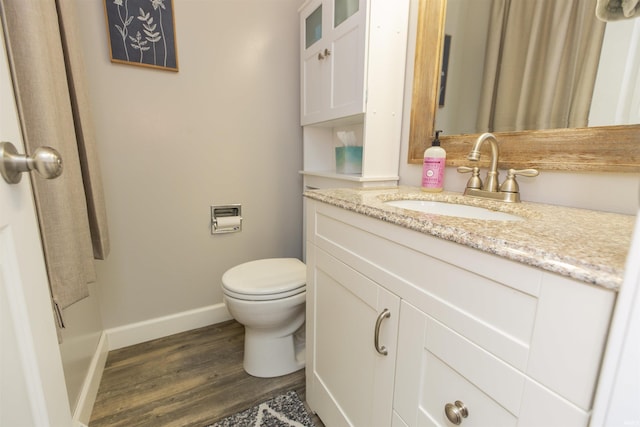 bathroom featuring hardwood / wood-style floors, vanity, and toilet