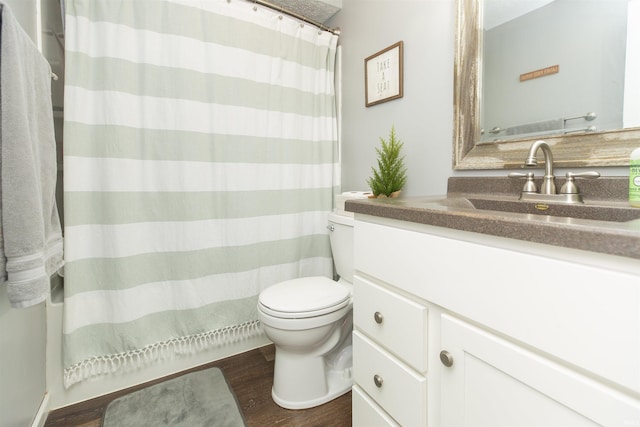 bathroom with vanity, wood-type flooring, and toilet