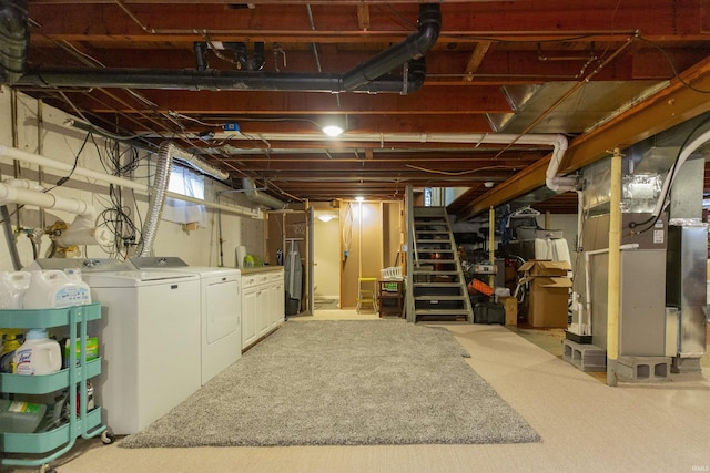 basement featuring washing machine and clothes dryer and carpet