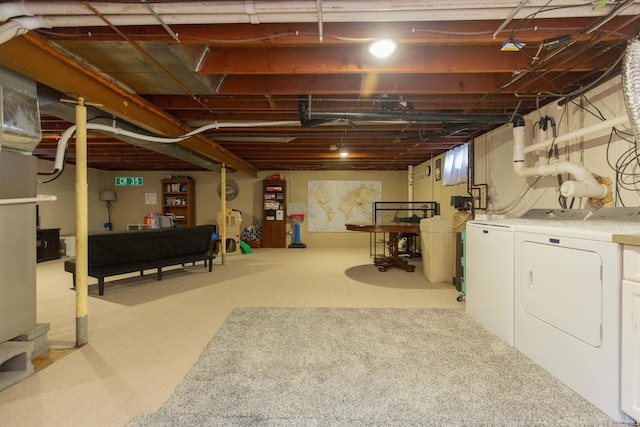 basement featuring washer and clothes dryer and light colored carpet