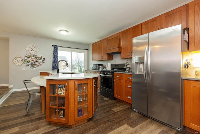 kitchen featuring sink, dark hardwood / wood-style flooring, stainless steel fridge, black range with gas cooktop, and custom exhaust hood