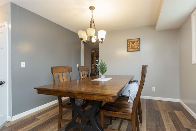 dining space featuring dark hardwood / wood-style floors and a notable chandelier