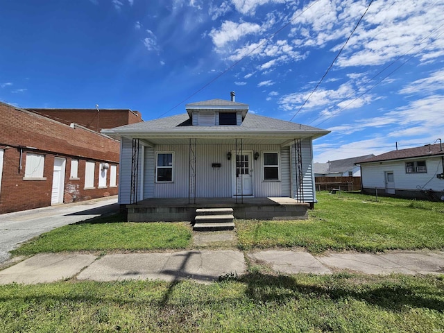 bungalow with a porch and a front lawn