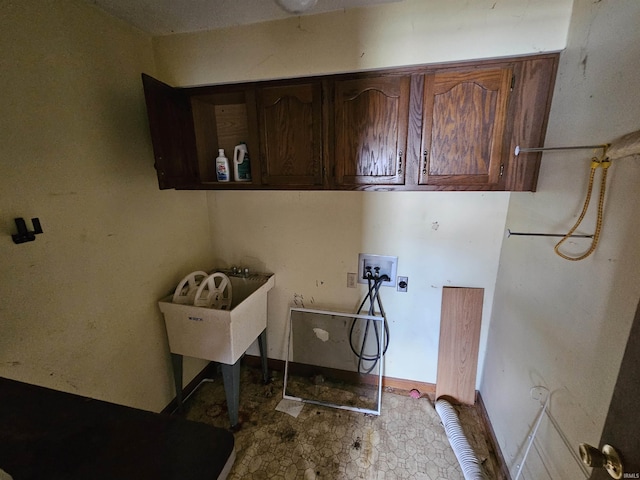 laundry room featuring hookup for an electric dryer, hookup for a washing machine, and cabinets