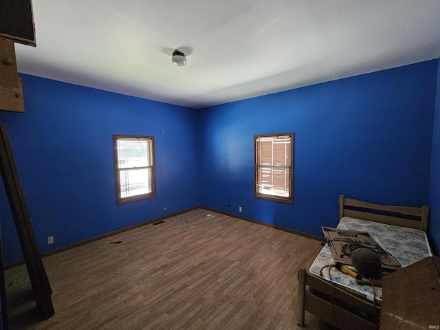 unfurnished bedroom with dark wood-type flooring