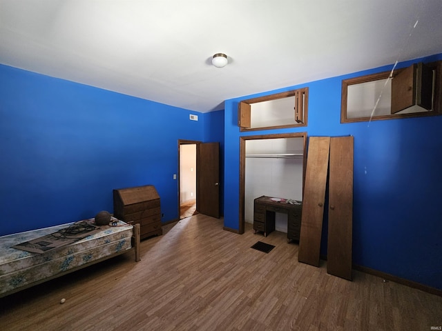 unfurnished bedroom featuring a closet and dark hardwood / wood-style flooring