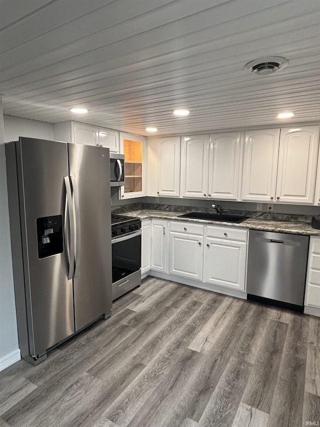 kitchen featuring white cabinets, hardwood / wood-style floors, stainless steel appliances, and sink