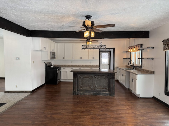 kitchen featuring a textured ceiling, beam ceiling, black range, white cabinets, and dark hardwood / wood-style floors