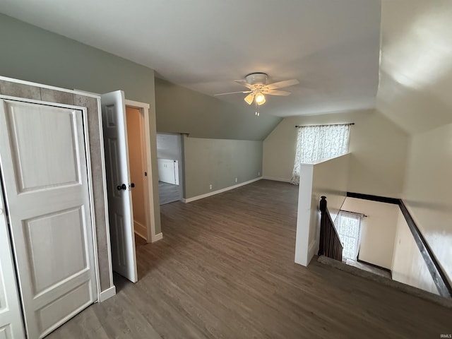 bonus room featuring dark hardwood / wood-style flooring, vaulted ceiling, and ceiling fan