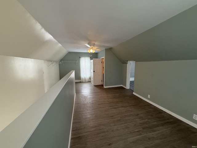 bonus room with ceiling fan, dark wood-type flooring, and vaulted ceiling