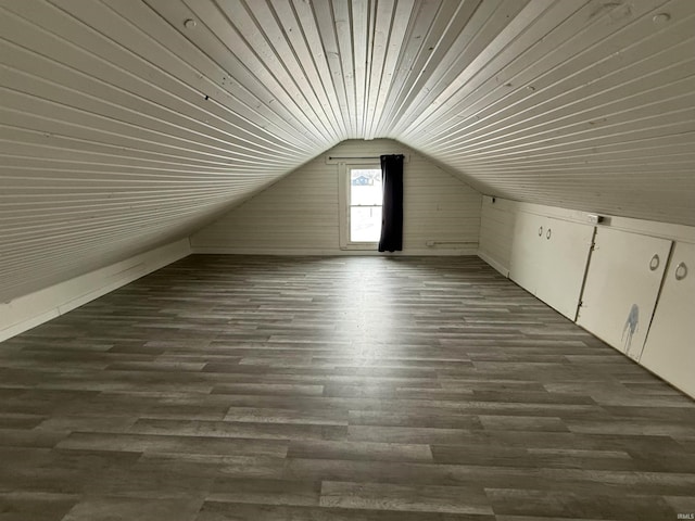 additional living space featuring dark hardwood / wood-style flooring and vaulted ceiling