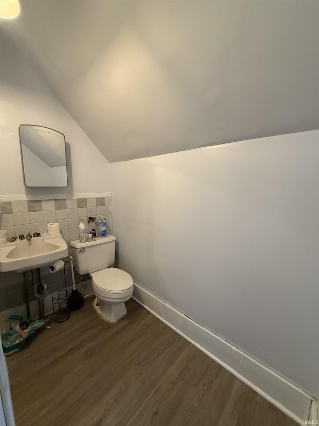 bathroom featuring tasteful backsplash, sink, hardwood / wood-style floors, toilet, and lofted ceiling