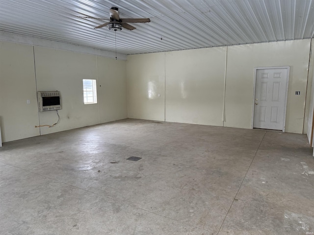 garage featuring heating unit and ceiling fan