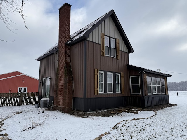 view of snow covered rear of property