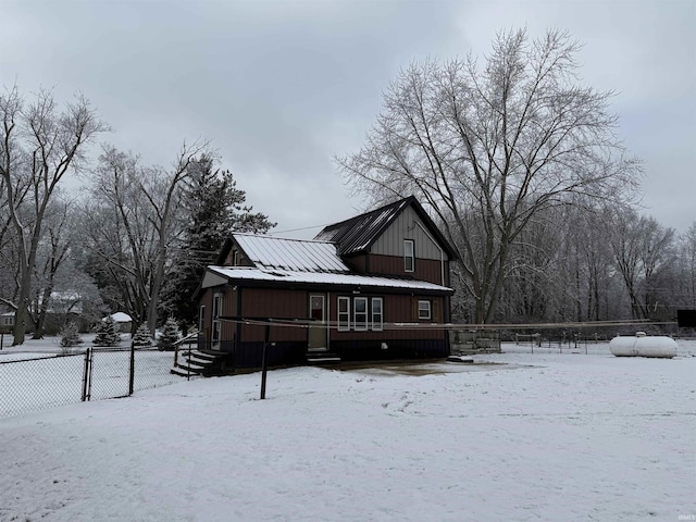 view of snow covered rear of property