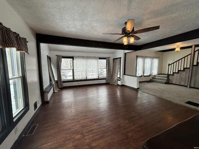 unfurnished living room featuring a textured ceiling, dark hardwood / wood-style floors, baseboard heating, and ceiling fan