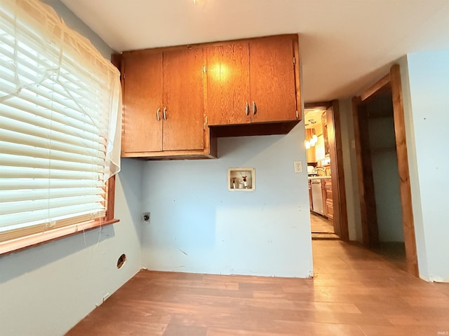 clothes washing area featuring cabinets, washer hookup, light wood-type flooring, and electric dryer hookup