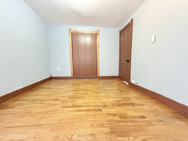 unfurnished bedroom featuring light wood-type flooring