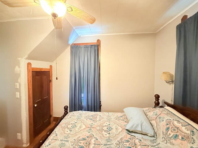 bedroom with ceiling fan, crown molding, and vaulted ceiling