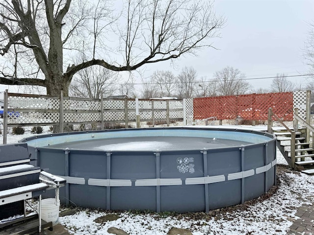 snow covered pool with grilling area