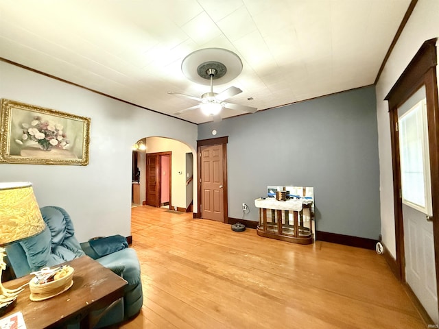 living area with ceiling fan and light hardwood / wood-style floors