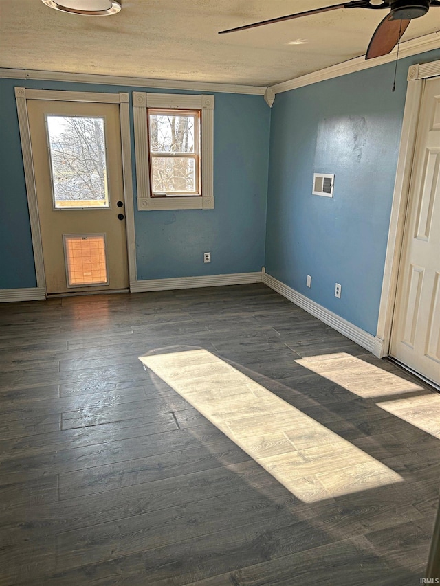 entryway with dark hardwood / wood-style floors, ceiling fan, and ornamental molding