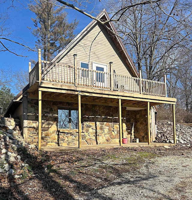 back of house featuring a wooden deck