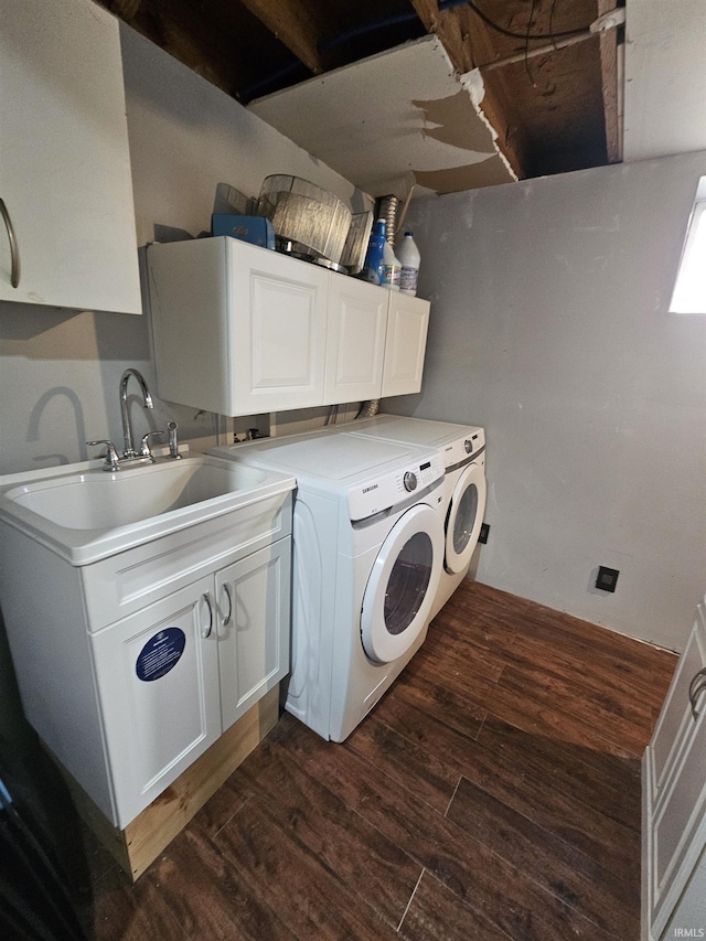 washroom featuring washer and clothes dryer, dark hardwood / wood-style flooring, cabinets, and sink