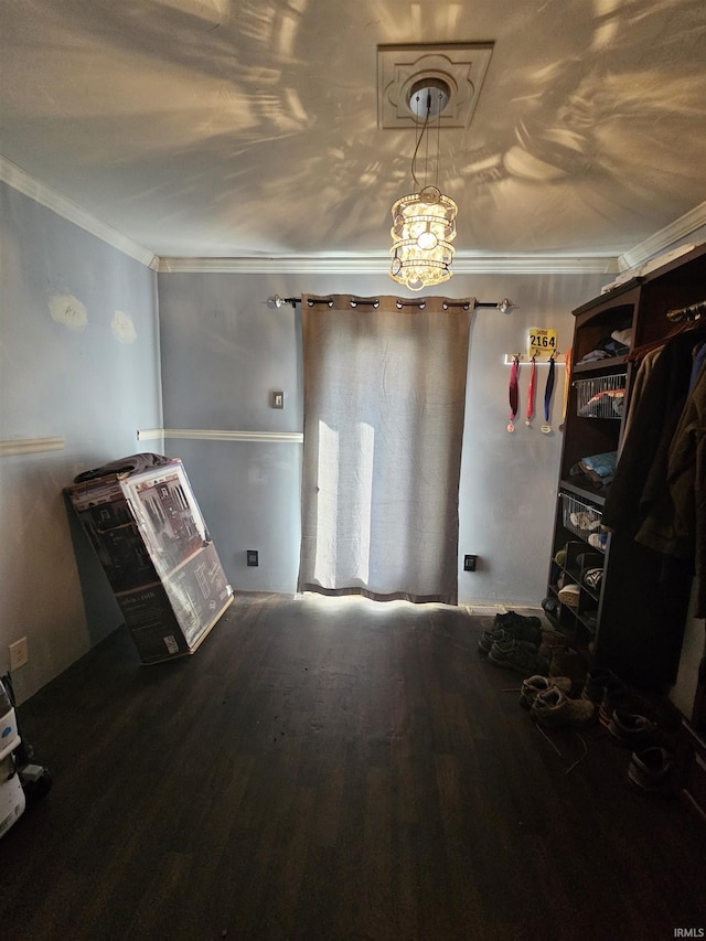 interior space with hardwood / wood-style floors and crown molding