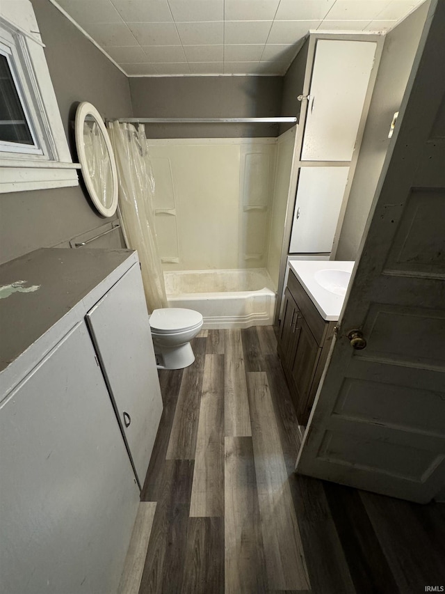 full bathroom with vanity, toilet, wood-type flooring, and shower / bath combo