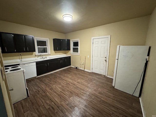 kitchen featuring dark hardwood / wood-style flooring, sink, and white appliances